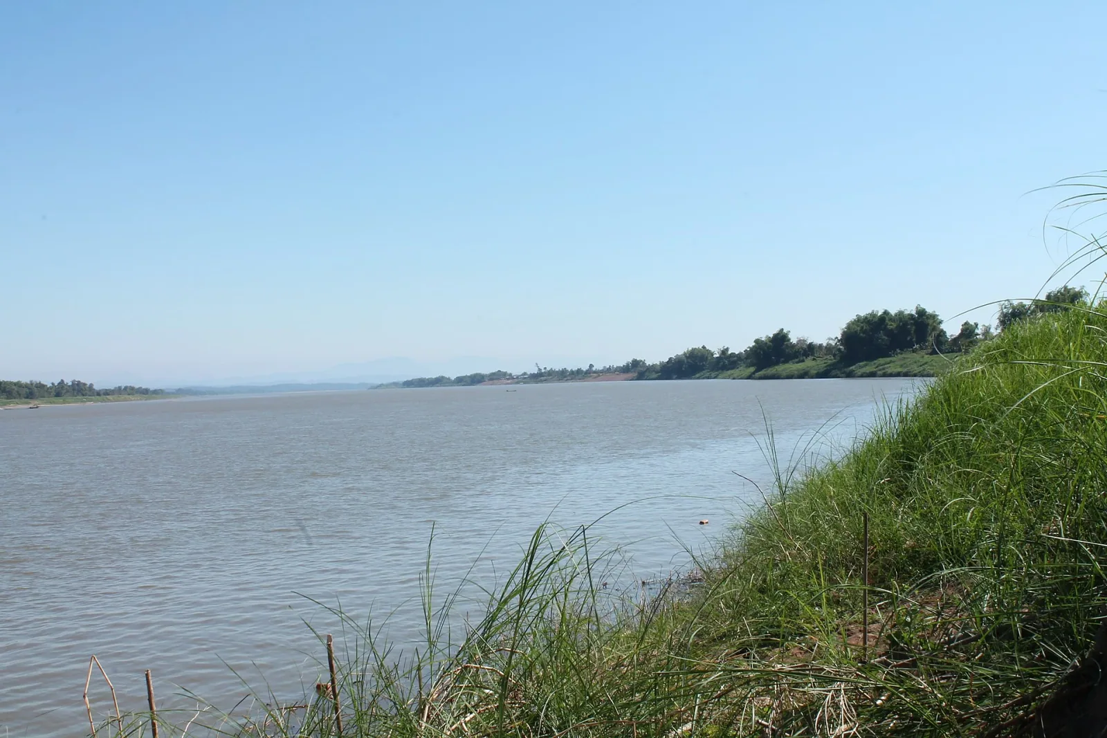 Wide calm Mekong River under a clear blue sky in Bueng Kan province